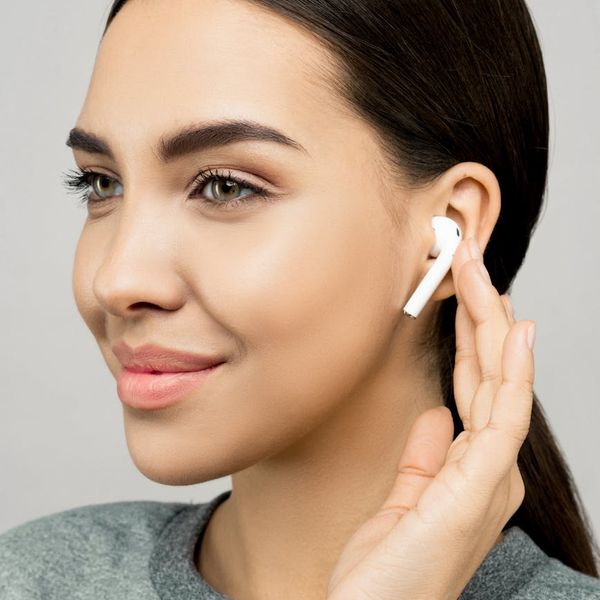 A person smiling with eyes closed, looking serene and content.